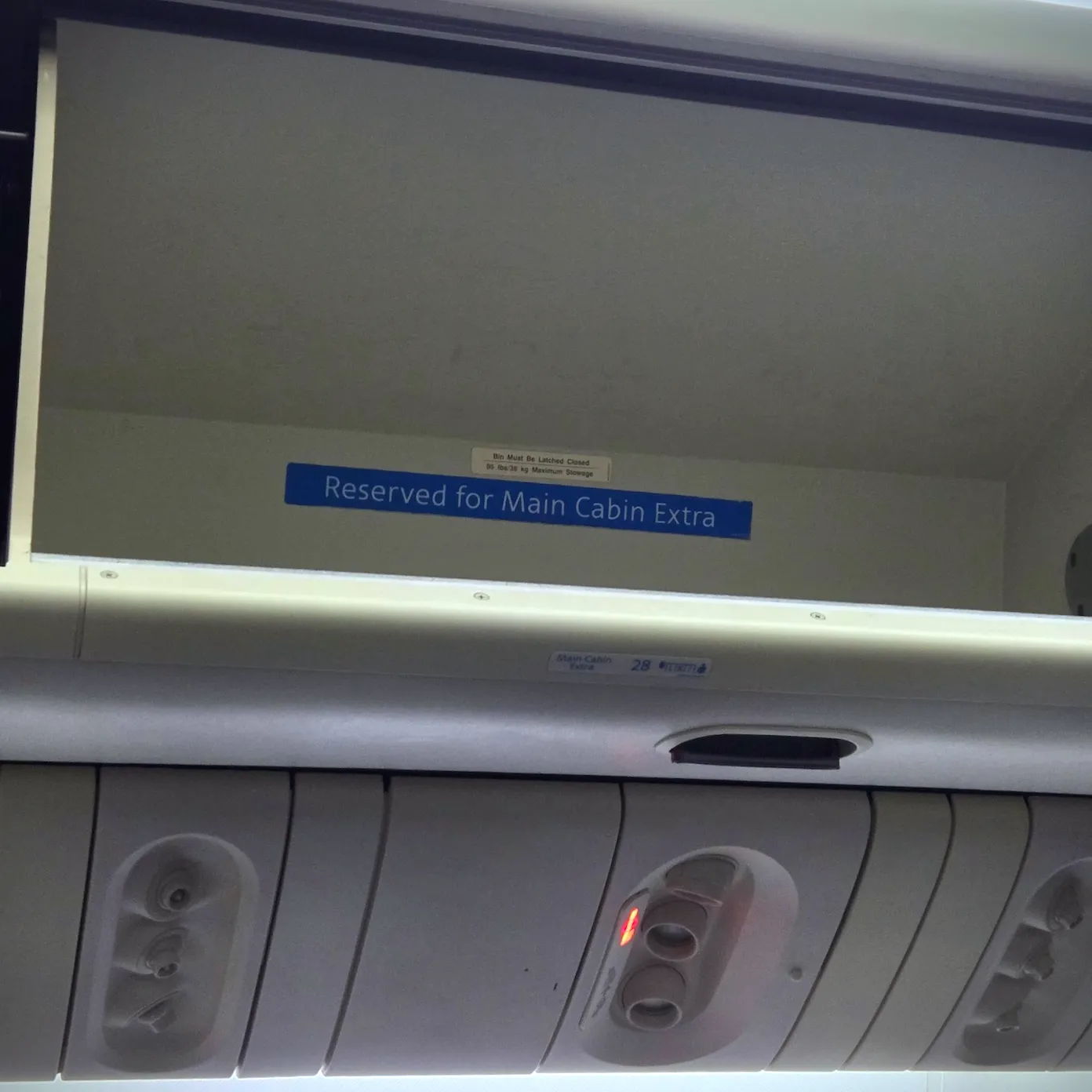 Safety Card, Main Cabin Extra Overhead Bin, and Overhead Reading Lights on American Airlines B777-200ER