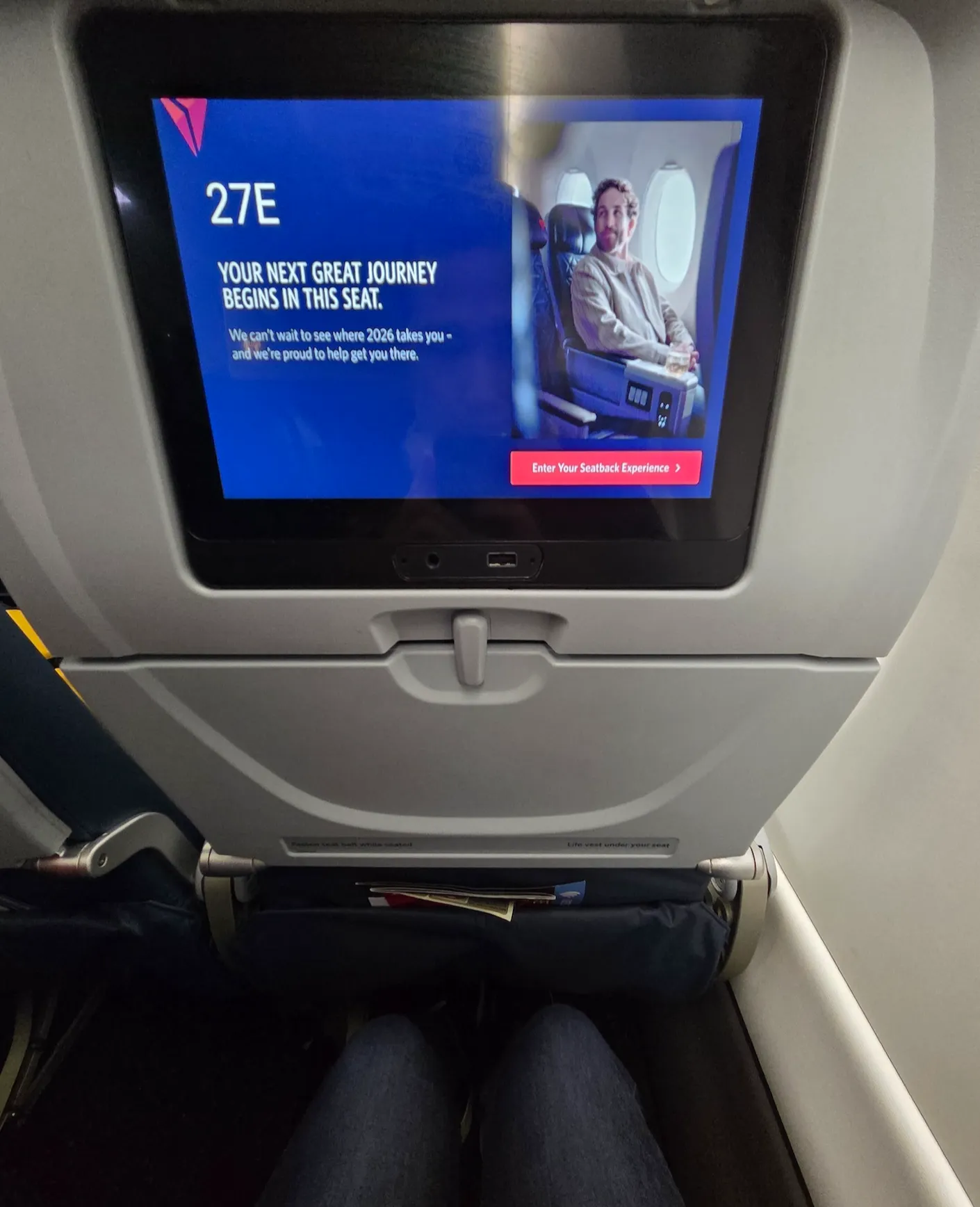 Delta Air Lines A220-100 Main Cabin entertainment screen and power outlet